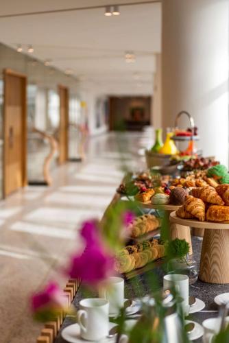 a buffet line with different types of pastries and bread at Andaz Condesa Mexico City, By Hyatt in Mexico City