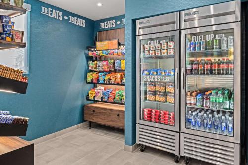 a store with a refrigerator with drinks and soda at Hampton Inn by Hilton Costa Mesa Newport Beach in Costa Mesa