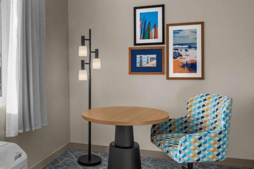 a table and a chair in a room at Hampton Inn by Hilton Costa Mesa Newport Beach in Costa Mesa