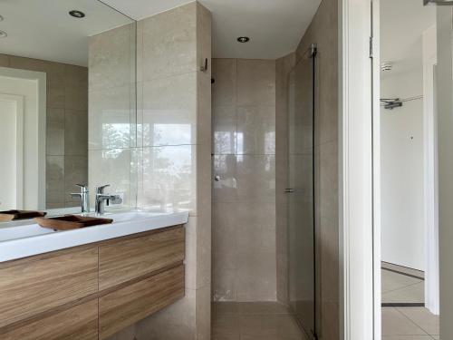 a bathroom with a sink and a shower at Best Beachfront Location In Manly w Stunning Views in Sydney