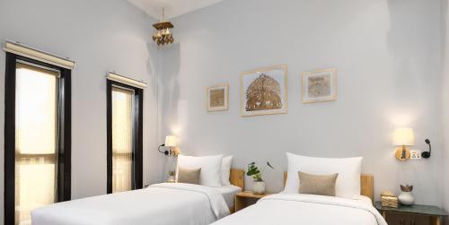 Ένα ή περισσότερα κρεβάτια σε δωμάτιο στο Moringa Tree Maison