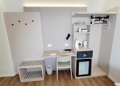 a small room with a desk and a table at Hotel Aurora Duino in Duino