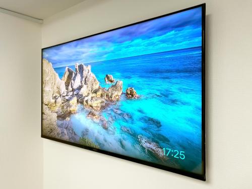 a flat screen tv hanging on a wall at YayoiHotel in Tokyo