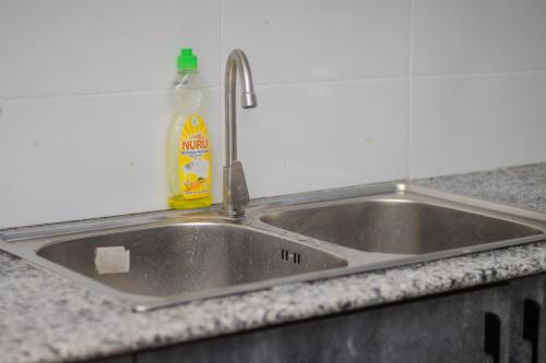 a kitchen sink with a bottle of detergent next to it at Cnc BnB-Kimana-2bedrooms in Oloitokitok 
