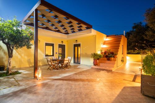 a patio of a house with a wooden pergola at Elpida's house in Ierápetra