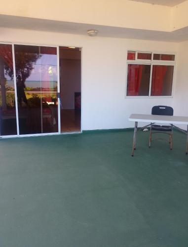 a white room with a table and chairs in it at Pension Ataha RAIVAVAE in Vaiuru