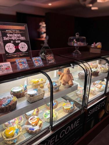 a display case filled with different types of food at HOTEL AMARIS & HIP (Adult Only) in Kanazawa