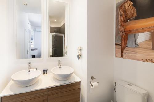 une salle de bain avec deux lavabos et un miroir dans l'établissement Center of Cannes 100m2 bright apartment, à Cannes