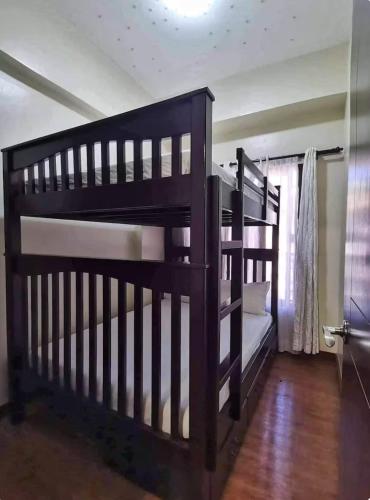 two sets of bunk beds in a room at Casa Cielo Baguio at Outlook Ridge Residences in Baguio