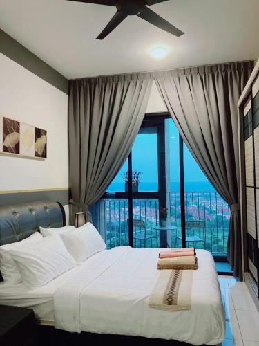 a bedroom with a bed with a view of the ocean at Quiet Scenic High Floor Parkview at Skytrees, 1-3 pax in Johor Bahru