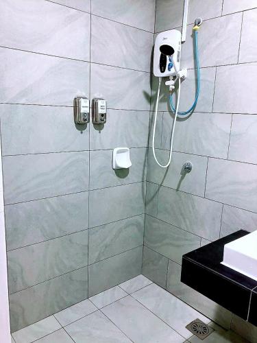 a bathroom with a shower with a glass door at Quiet Scenic High Floor Parkview at Skytrees, 1-3 pax in Johor Bahru