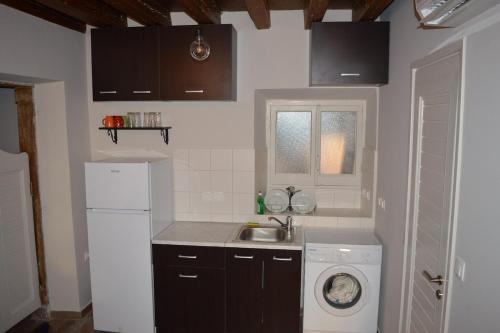 a kitchen with a sink and a washing machine at Lemonia apartment Old Town in Corfu