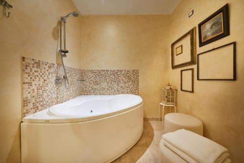 a white bath tub in a bathroom with a toilet at B&B Le Stanze del Duomo in Florence