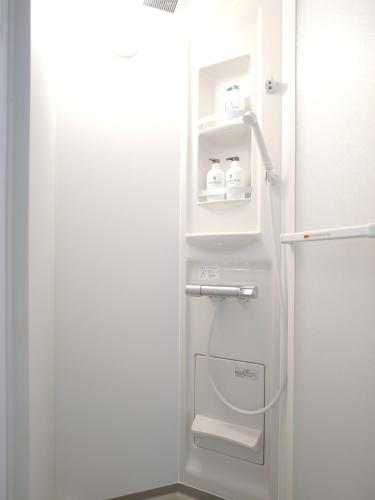 a bathroom with a shower with a toilet in it at YayoiHotel in Tokyo