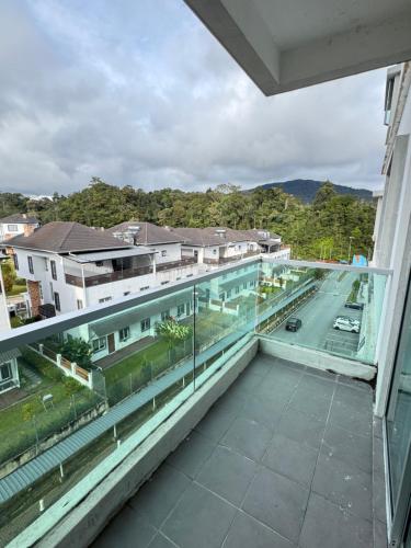 a balcony with a view of a street and buildings at AYAAN PLATINUM Foosball Home at Quintet Apartment Free Parking in Tanah Rata