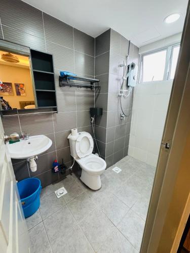 a bathroom with a toilet and a sink at AYAAN PLATINUM Foosball Home at Quintet Apartment Free Parking in Tanah Rata