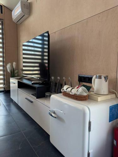 a kitchen with a white refrigerator in a room at Lake Park in Novomoskovsʼk