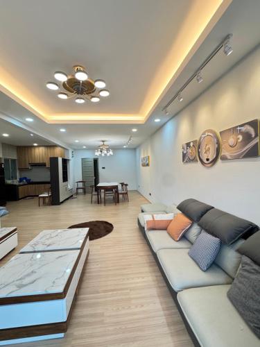 a living room with a couch and a dining room at AYAAN PLATINUM Foosball Home at Quintet Apartment Free Parking in Tanah Rata