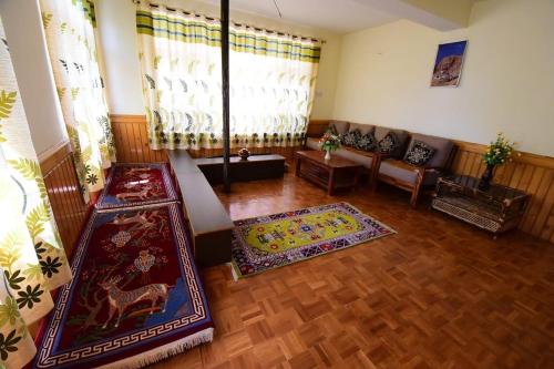 a living room with a couch and a rug at Spitihome homestay in Kaja