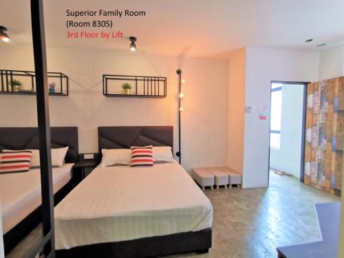 a bedroom with a bed in a room at Mwv Family Suite Room in Muar