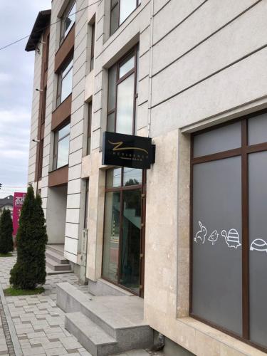 a building with a sign on the side of it at Z Residence in Curtea de Argeş