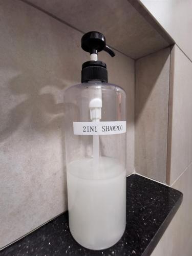 a bottle of milk sitting on a counter at Mwv Family Suite Room in Muar