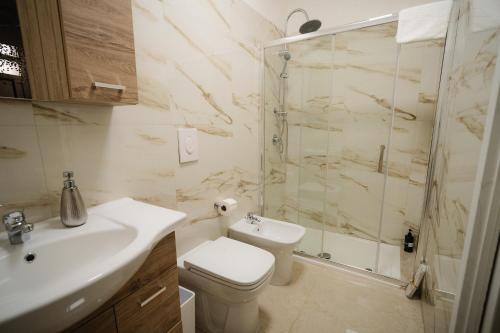 a bathroom with a toilet and a shower and a sink at Puglia Mar in Mola di Bari