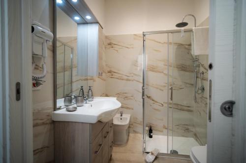 a bathroom with a sink and a shower at Puglia Mar in Mola di Bari
