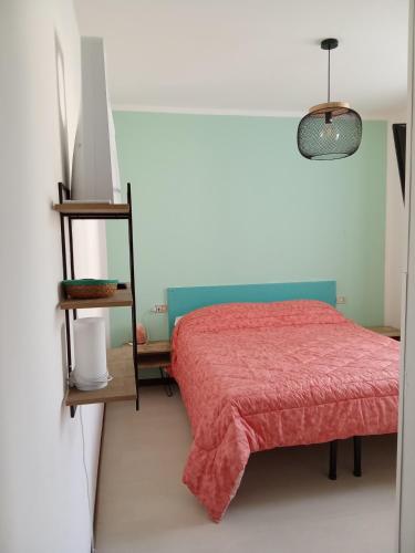 a bedroom with a bed with a red bedspread at Locanda dei pescatori in Domaso