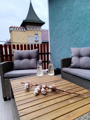 a table on a patio with two couches and flowers on it at Apartmán Waldruh s terasou in Jalŭvčí