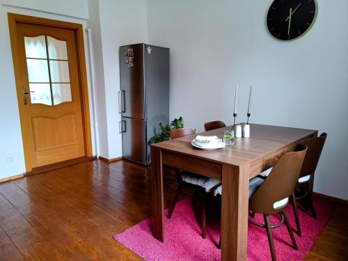 a dining room with a table and a refrigerator at Apartmán Waldruh s terasou in Jalŭvčí