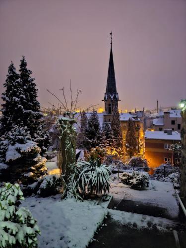 a view of a city in the snow with a church at Apartmán Waldruh s terasou in Jalŭvčí