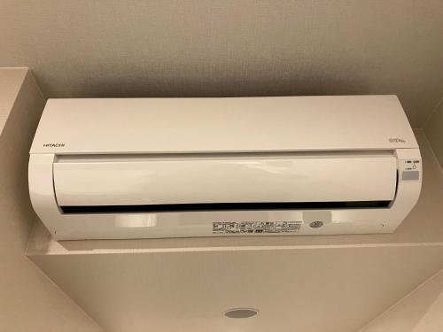 a white printer sitting on top of a ceiling at Smile Hotel Okayama in Okayama