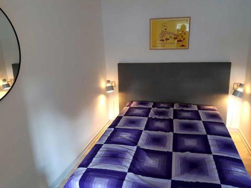 a bedroom with a bed in a room with lights at Cozy Apartment In Old Farm in Svaneke