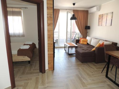 a living room with a couch and a table at Dunavski kutak in Veliko Gradište