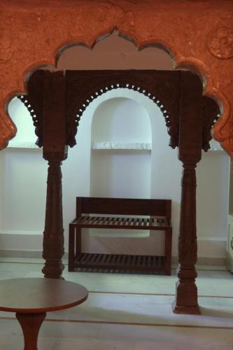 a table in a room with a wooden archway at Dev Niwas - Heritage Hotel in Būndi