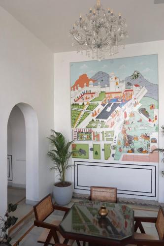 a living room with a large painting on the wall at Dev Niwas - Heritage Hotel in Būndi