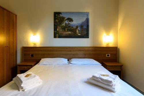a bedroom with a bed with two towels on it at Hotel Ideale in Bologna