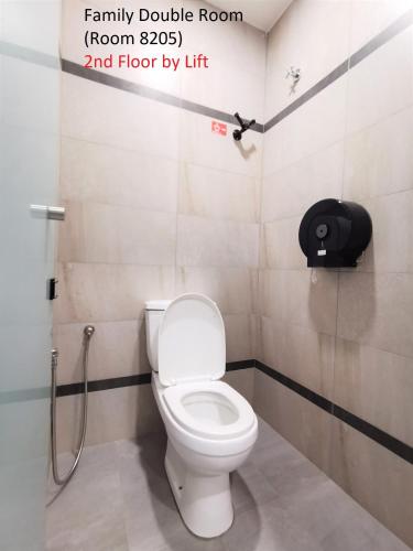 a bathroom with a toilet in a bathroom stall at Mwv Family Suite Room in Muar