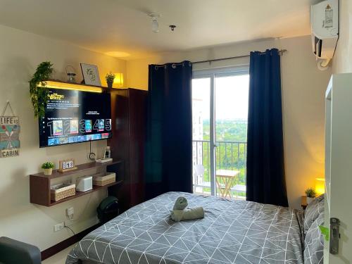 a bedroom with a bed and a sliding glass door at Cel Escapia in Lapu Lapu City