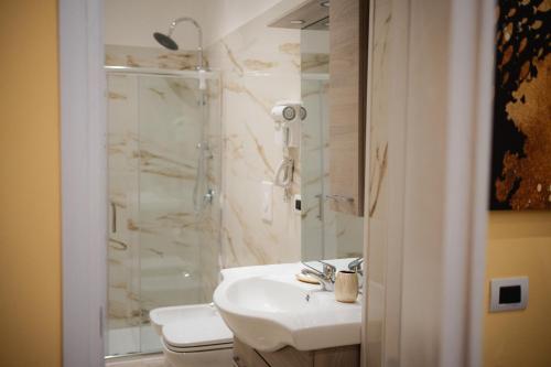 a bathroom with a shower and a sink and a toilet at Puglia Mar in Mola di Bari