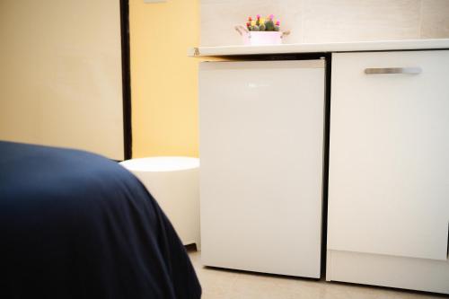 a white refrigerator in a room with a counter at Puglia Mar in Mola di Bari
