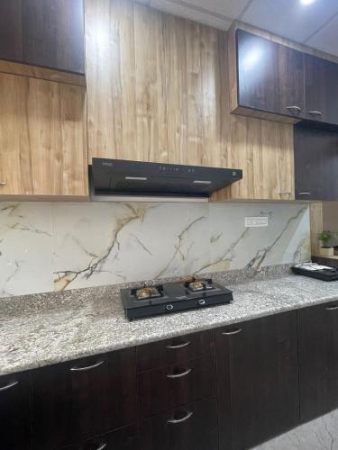 a kitchen with a stove and a counter top at Karma Stay in Jaigaon