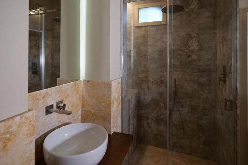 a bathroom with a sink and a shower at Delcorto Suites in Montepulciano