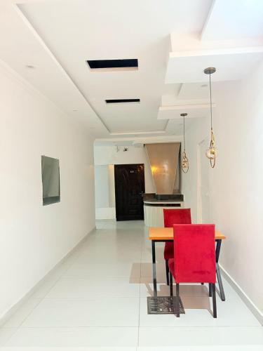 a dining room with a table and red chairs at Hotel Tulip Inn, Gulberg in Lahore