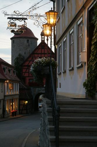 a street light next to a building with stairs at Gasthof zur Post in Langenburg