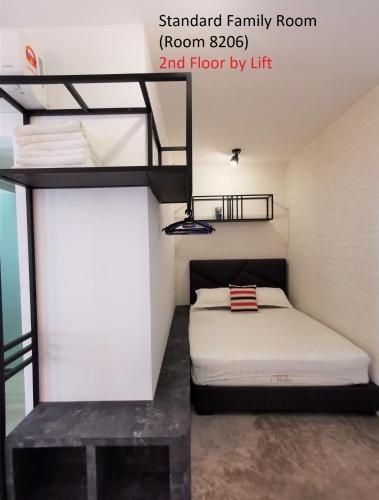 a bedroom with a bed in a loft at Mwv Family Suite Room in Muar