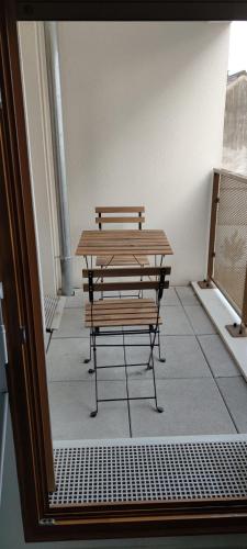 - une table et un banc dans une chambre avec fenêtre dans l'établissement l'incontournable Villepinte Parc des expositions, à Villepinte