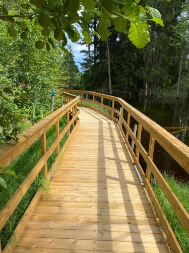 a wooden bridge over a body of water at Älvängs natur & kulturhus in Tärnsjö