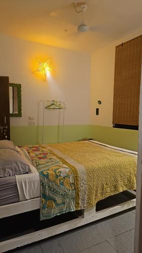 a bedroom with a bed with a star on the wall at Laxmi Happy Home in Querim Goa in Querim